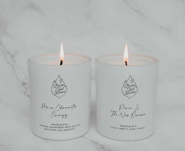 The two Healing Era candles lit side by side