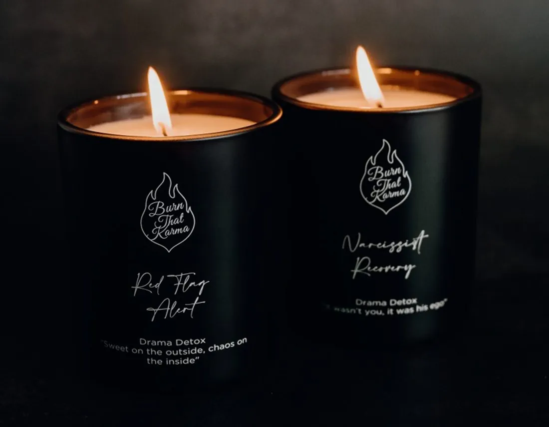The two Drama Detox candles lit side by side