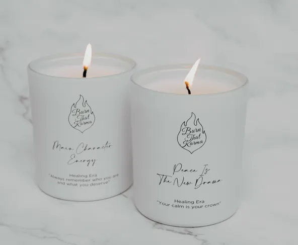 The two Healing Era candles lit side by side