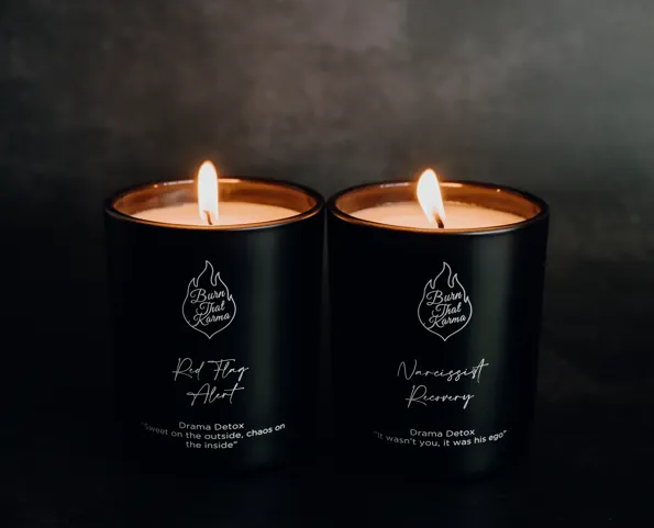 The two Drama Detox candles lit side by side